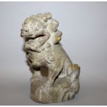 AN EARLY 20TH CENTURY CHINESE STONE CARVING OF A BUDDHISTIC LION, seated on its haunches with