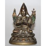 A GOOD 18TH CENTURY SINO-TIBETAN BRONZE MODEL OF A LAMA, the priest sitting in dhyanasana on a