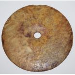 AN ARCHAIC STYLE JADE-LIKE BI DISC, of larger than average size, one surface carved in low relief