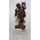 A SMALL EARLY 20TH CENTURY CHINESE CARVED WOOD FIGURE OF AN IMMORTAL, mounted on a fixed perspex