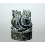 AN EARLY 20TH CENTURY CHINESE CARVED JADE SEAL, of circular section, the plinth surmounted by a