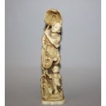 AN EARLY 20TH CENTURY SIGNED JAPANESE CARVED IVORY GROUP OF A FISHERMAN & A BOY, standing on a rocky