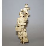 AN EARLY 20TH CENTURY JAPANESE CARVED IVORY FIGURE OF A STREET SELLER, in the company of two