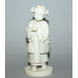 A FINE QUALITY SIGNED JAPANESE MEIJI PERIOD CARVED IVORY FIGURE OF A YOUNG GIRL, with a bag over her