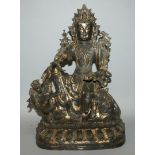 A LARGE GILT BRONZE MODEL OF WENSHU, seated on the back of a buddhistic lion, the deity with
