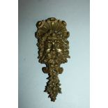 AN ORMOLU CAST BRACELET "Head of a man". 9ins long.