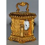 A MINIATURE GILT BRONZE CARRIAGE CLOCK with classical figure supports. 3.25ins high.