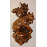 A GOOD BLACK FOREST CARVED WOOD BEAR WALL BRACKET. 11ins long.