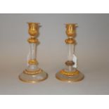 A GOOD PAIR OF CRYSTAL AND ORMOLU CIRCULAR CANDLESTICKS. 8ins high.