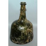 A SMALL EARLY GREEN MALLET SHAPED BOTTLE. 61/2ins high, 4ins diameter.