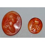 TWO SMALL CORNELIAN INTAGLIOS, one probably depicting Socrates, the other a Greek soldier.  0.