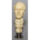 A 19TH CENTURY CARVED IVORY HANDLED SEAL, the white metal circular intaglio incised with a cannon,