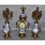 A 19TH CENTURY FRENCH BLUE AND WHITE DELFT DESIGN CLOCK AND MATCHING CANDELABRA with eight day