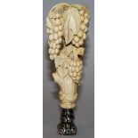 A RUSSIAN CARVED IVORY HANDLED DESK SEAL, carved with fruiting vines, the rectangular seal