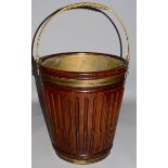 A GOOD IRISH MAHOGANY PEAT BUCKET with brass liner and carrying handle. 1ft 6ins high.