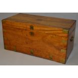 A 19TH CENTURY MILITARY CAMPHOR WOOD BRASS BOUND CHEST with rising top and brass carrying handles.