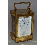 A FRENCH BRASS SERPENTINE FRONTED ALARM AND CARRIAGE CLOCK.  4.5ins high.