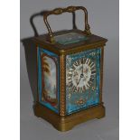 A MINIATURE BLUE ENAMEL AND BRASS CARRIAGE CLOCK painted with panels of flowers.  2.5ins high.