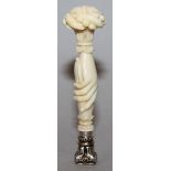 A 19TH CENTURY FRENCH CARVED IVORY DESK SEAL formed as a pair of joined hands with bouquet carved