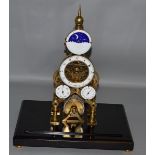 A LARGE BRASS SKELETON CLOCK "MOONFACE" with fusee movement Franz Denk, Wien in a glass case.  14ins