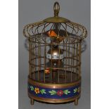 A SMALL BIRDCAGE CLOCK with two birds and cloisonn panel.8ins high.