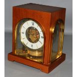 A VERY GOOD GRUEN GUILD ATMOS CLOCK, SWISS, in a wooden case with glass sides. 10ins high.