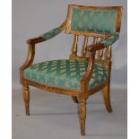 A 19TH CENTURY FRENCH GILTWOOD ARMCHAIR with upholstered rectangular back, spindle supports,