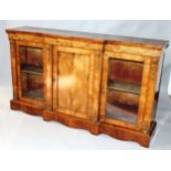 A VICTORIAN WALNUT BREAKFRONT CREDENZA with plain top, inlaid frieze and central panel doors,