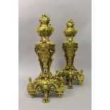 A SUPERB PAIR OF LOUIS XVI DESIGN BRASS FIRE DOGS with flaming urns, acanthus and pineapple