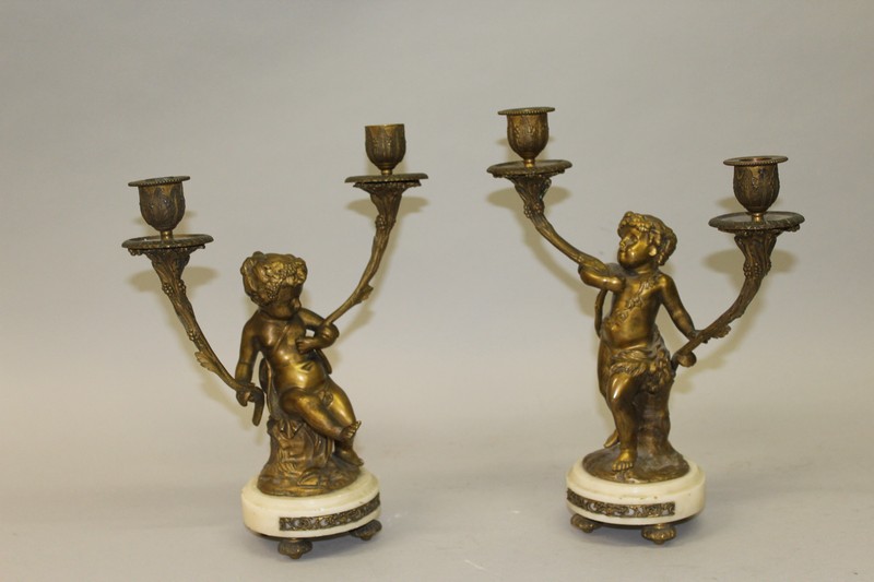 A GOOD PAIR OF 19TH CENTURY LOUIS XVI PATTERN CUPID BRONZE TWO LIGHT CANDLESTICKS on white