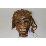AN AFRICAN CARVED WOOD MASK. 11ins long.