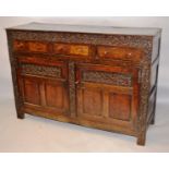 A 17TH CENTURY/18TH CENTURY OAK DRESSER, the rectangular plank top over a carved frieze and