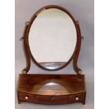 A GEORGIAN MAHOGANY BOWFRONTED TOILET MIRROR with oval mirror, curving supports, bowfronted base