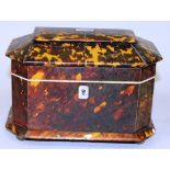 A REGENCY TORTOISESHELL TWO DIVISION TEA CADDY with cut off corners, ivory frame, supported on