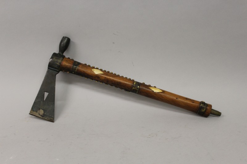 A RARE INDIAN TOMAHAWK WOODEN AND METAL AXE PIPE with diamond cut bone inlay 17ins long.