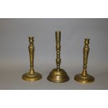 A PAIR OF 19TH CENTURY FRENCH ORMOLU CIRCULAR CANDLESTICKS, 10.5ins high, and an EARLIER BRASS