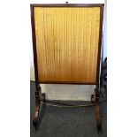 A REGENCY MAHOGANY FIRE SCREEN with silk-work panels.