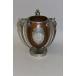 A PAIRPOINT MIXED METAL THREE HANDLED CHALLICE CUP with mask handle and oval cartouche, engraved R