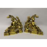 A PAIR OF LOUIS XVI ORMOLU CHENETS with cupids and acanthus 12ins wide.
