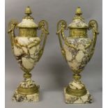 A GOOD PAIR OF LOUIS XVI STYLE VEINED MARBLE AND ORMOLU TWO HANDLED URNS AND COVERS, with red ormolu