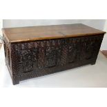 A GOOD LARGE 17TH CENTURY OAK COFFER with two plank top of superb colour, iron hinge and lock, the