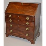 A GEORGIAN MAHOGANY BUREAU with fall front interior over four long graduated drawers, circular brass