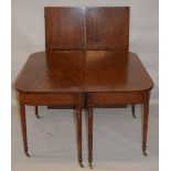 AN EARLY 19TH CENTURY AND LATER MAHOGANY EXTENDING DINING TABLE, with a pair of rounded