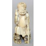 A 19TH/20TH CENTURY JAPANESE IVORY OKIMONO OF A SAGE, holding a gourd and staff and standing on