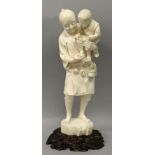 A LARGE FINE QUALITY SIGNED JAPANESE MEIJI PERIOD TOKYO SCHOOL IVORY OKIMONO OF A MAN HOLDING A