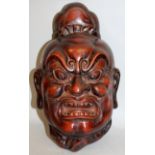 A GOOD QUALITY JAPANESE MEIJI PERIOD RED LACQUERED BRONZE MASK OF AN ONI, the demon with fierce