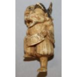 A 19TH/20TH CENTURY JAPANESE STAINED AND CARVED IVORY NETSUKE OF EBISU, standing on one leg with a