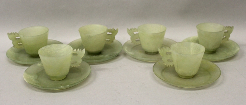 A 20TH CENTURY CHINESE GREEN JADE-LIKE SET OF CUPS & SAUCERS, comprising six flaring cups with
