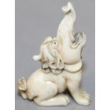 A 19TH/20TH CENTURY JAPANESE CARVED IVORY NETSUKE OF A BAKU, seated with raised trunk, 1.9in high.