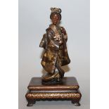 A GOOD SIGNED JAPANESE MEIJI PERIOD EISUKE MIYAO PARCEL GILT BRONZE FIGURE OF A LADY, mounted on a